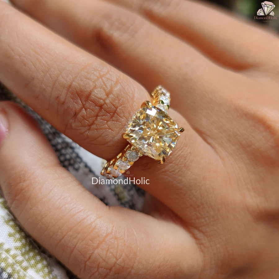 Diamond Holic Cushion Cut Moissanite Wedding Ring with sparkling side stones on finger