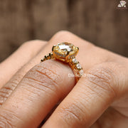 Cushion Cut Moissanite Wedding Ring in gold setting with side stones worn on finger by Diamond Holic