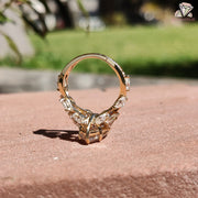 Diamond Holic gold ring featuring a sparkling Marquise Diamond centerpiece with surrounding smaller stones