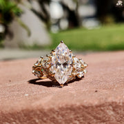Diamond Holic ring featuring a large Marquise Diamond centerpiece with smaller diamonds set in gold band