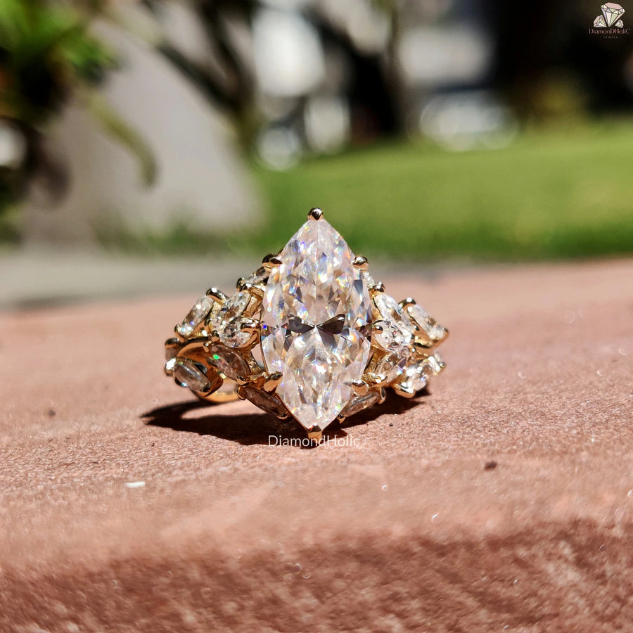 Diamond Holic ring featuring a large Marquise Diamond centerpiece with smaller diamonds set in gold band