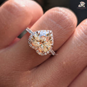 Diamond ring held between fingers with 'DiamondHolic' branding.

