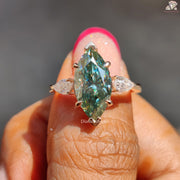 Cyan blue marquise moissanite three stone ring - close-up