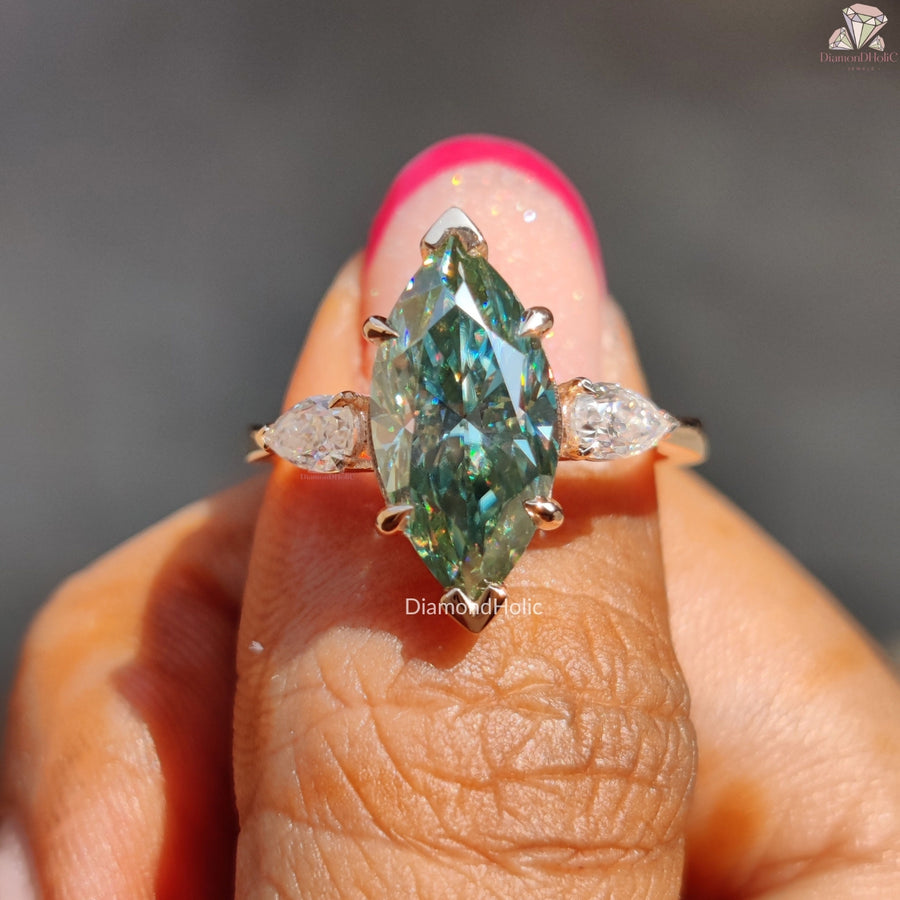 Cyan blue marquise moissanite three stone ring - close-up