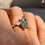 Cyan blue marquise moissanite three stone ring - lifestyle shot