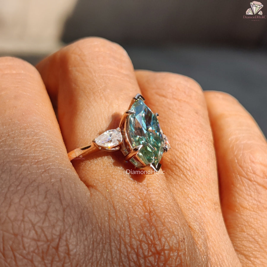 Cyan blue marquise moissanite three stone ring - lifestyle shot