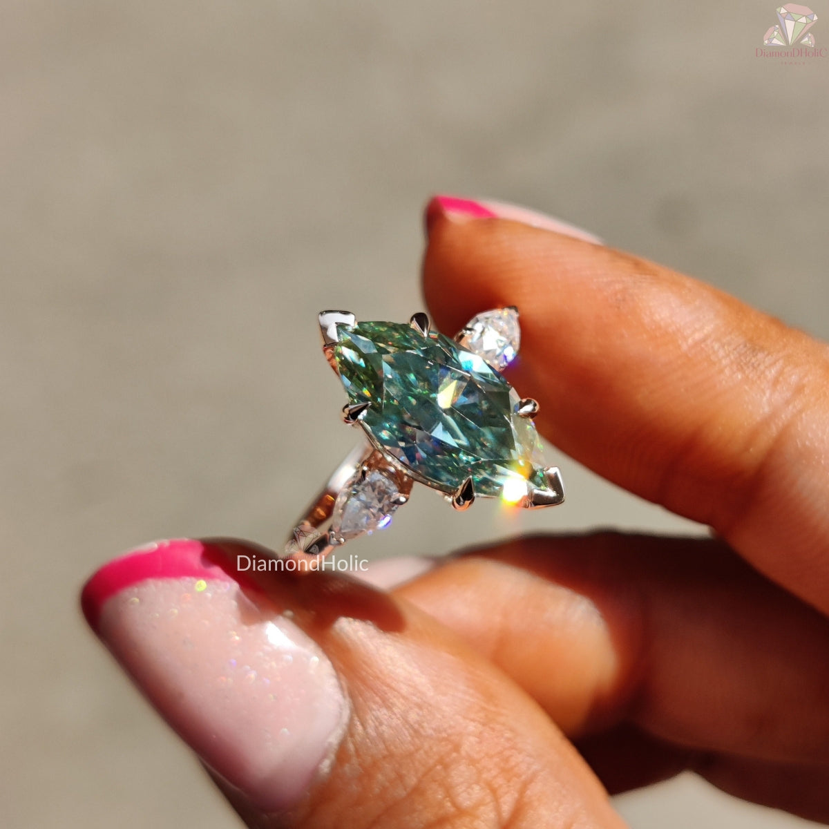 Cyan blue marquise moissanite three stone ring - side angle