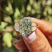 8.10 CT Radiant Cut Light Green Moissanite Three Stone Engagement Ring by Diamond Holic held in hand