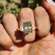 8.10 CT Radiant Cut Light Green Moissanite Three Stone Engagement Ring on finger by Diamond Holic