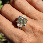 8.10 CT Radiant Cut Light Green Moissanite Three Stone Engagement Ring by Diamond Holic on finger