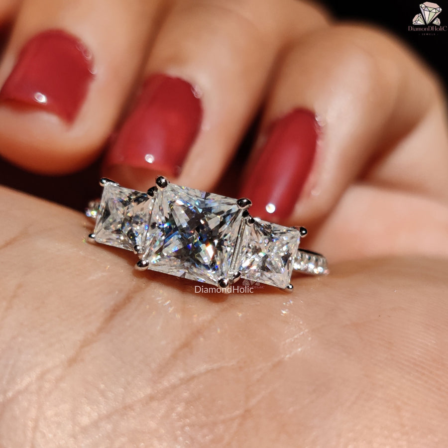 Diamond Holic princess cut moissanite ring with three sparkling stones worn on finger