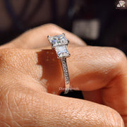 Diamond Holic princess cut moissanite ring with sparkling side stones on a hand