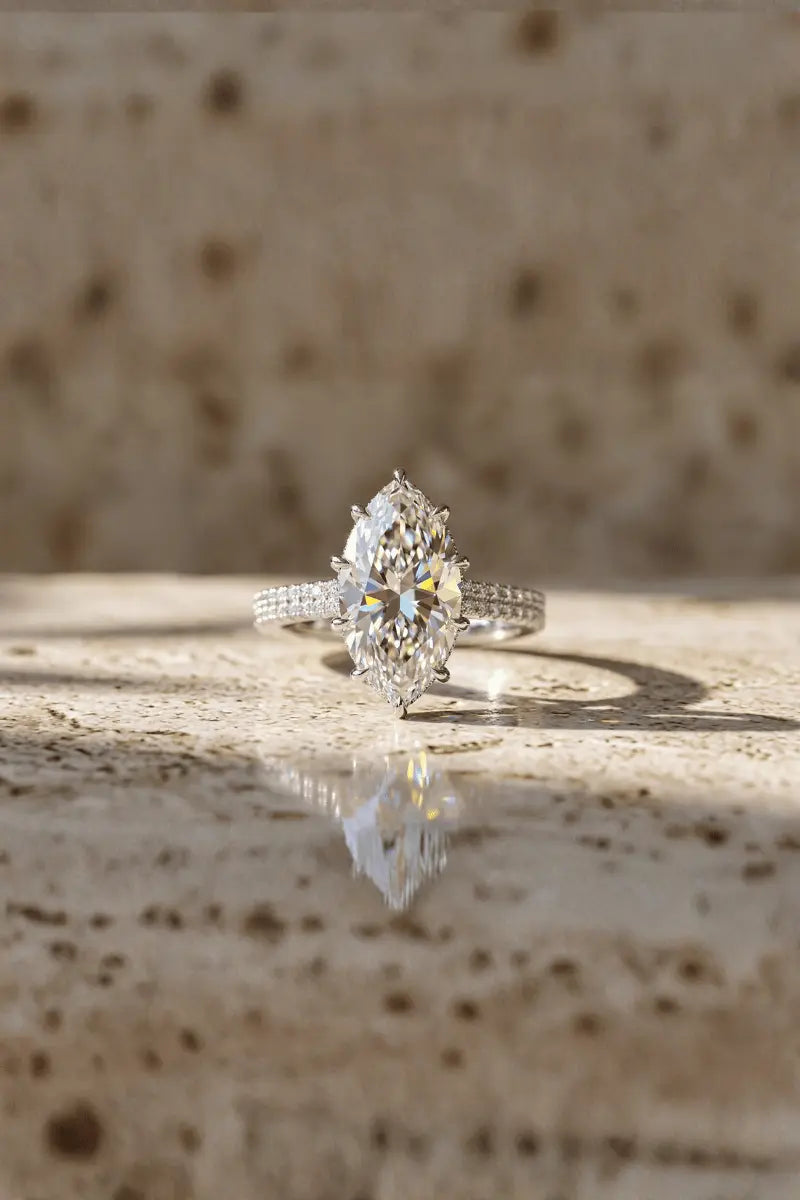 Diamond ring on a reflective surface with a textured background